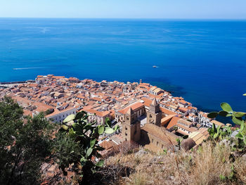 High angle view of townscape by sea against sky