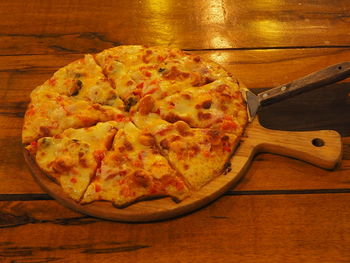 High angle view of pizza on cutting board