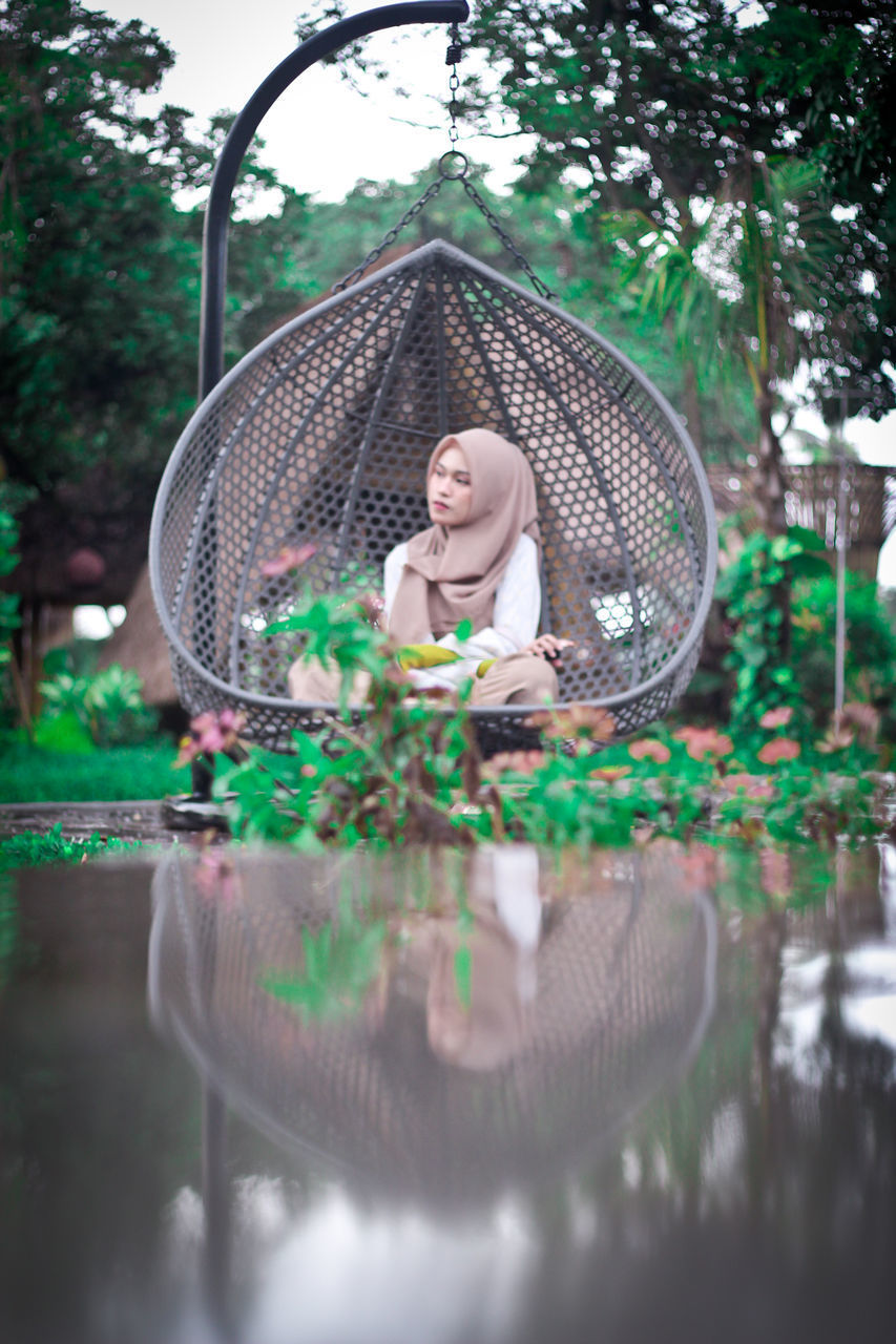 YOUNG WOMAN WITH REFLECTION ON TREE