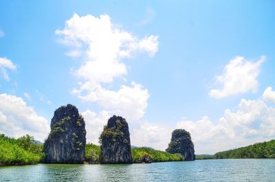 Panoramic shot of rocks by sea against sky