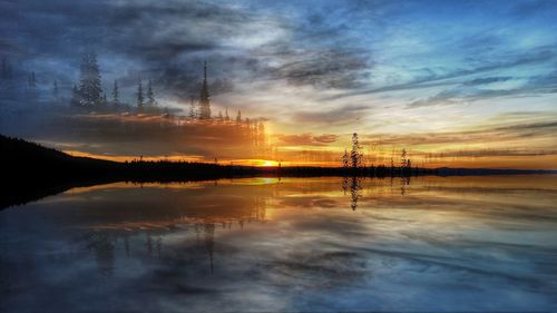 Silhouette electricity pylon by lake against sky during sunset