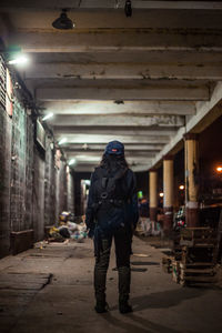 Full length of man standing in illuminated building