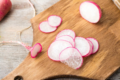 Fresh sliced radish on a cutting board on a wooden table. vegetables for a vegetarian diet