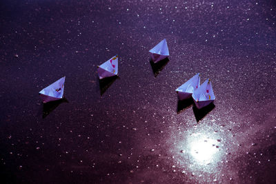 High angle view of paper boats on wet street