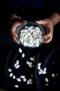 Midsection of woman holding coffee beans