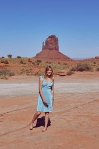 Portrait of woman standing at monument valley