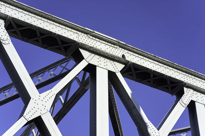 Low angle view of bridge against clear blue sky
