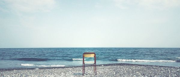Empty chair on calm beach
