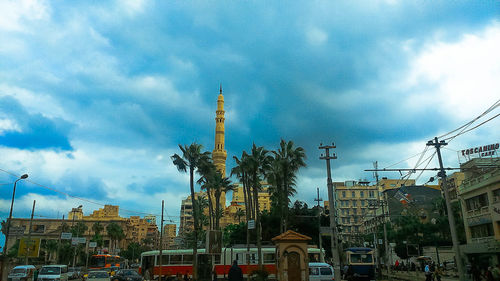 View of cityscape against cloudy sky