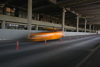 BLURRED MOTION OF CAR ON BRIDGE