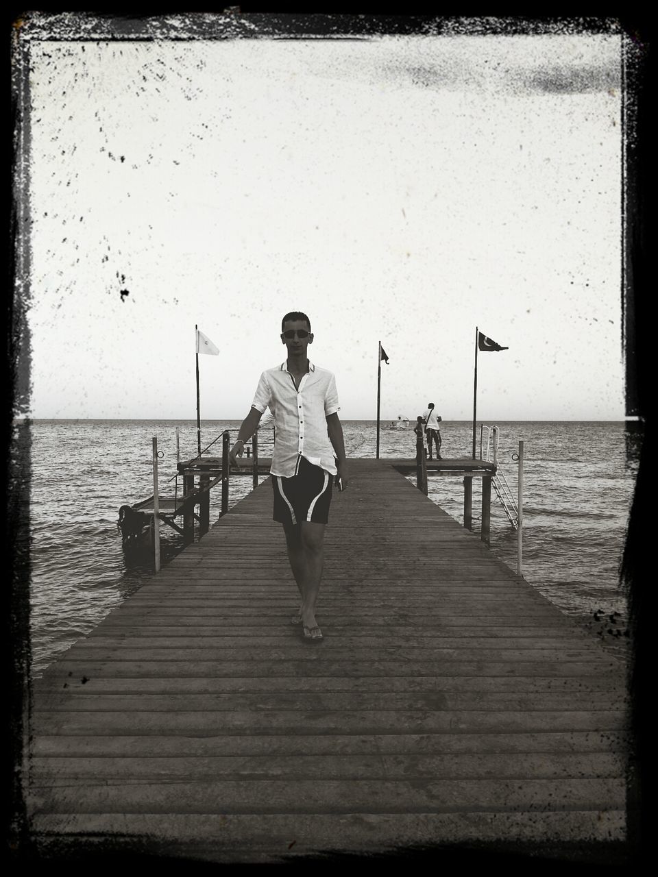 sea, water, rear view, pier, lifestyles, horizon over water, leisure activity, full length, transfer print, men, person, wood - material, tranquil scene, tranquility, standing, sky, nature, auto post production filter