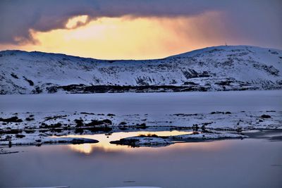 Scenic view of snowcapped mountains against sky during sunset