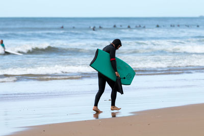 Full length of man standing on beach