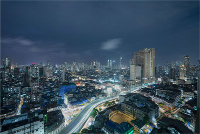 Aerial view of illuminated city buildings at night