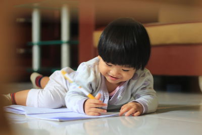 Portrait of boy sitting on table