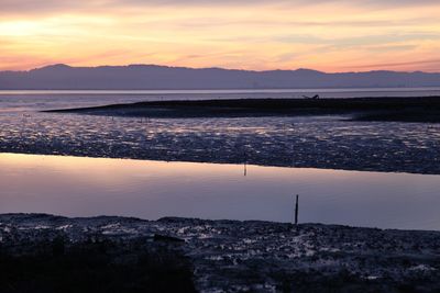 Scenic view of mountain range at sunset