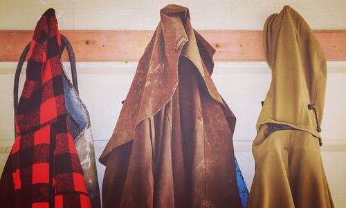 Close-up of clothes hanging on wooden wall