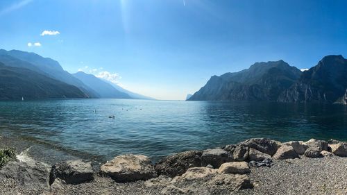 Scenic view of sea and mountains against sky