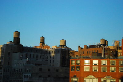 Low angle view of buildings against clear blue sky