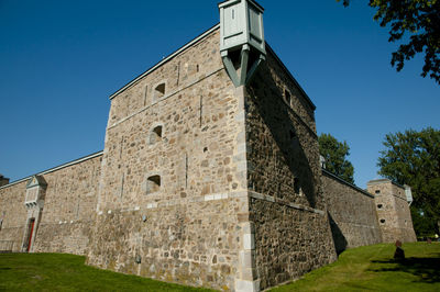 Low angle view of historic building against blue sky