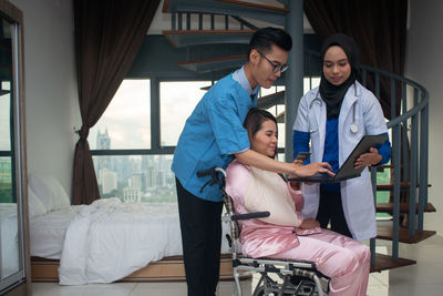 Young couple standing in bed