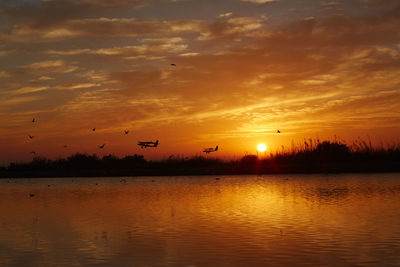 Scenic view of lake against sky during sunset