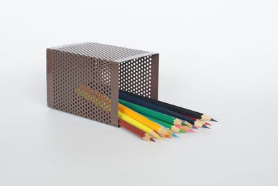 Close-up of colored pencils against white background