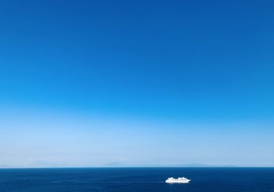 Scenic view of cruise and sea against clear blue sky