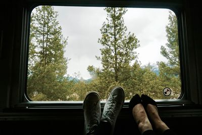 Low section of man in car against sky