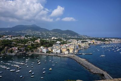 High angle view of city by sea against sky