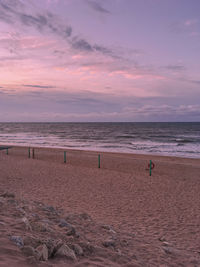 Scenic view of beach against sky during sunset