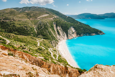 Scenic view of sea and mountains against sky