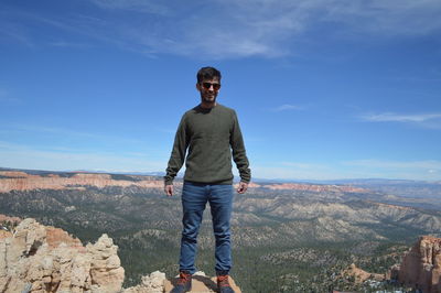 Smiling man standing on rock at bryce canyon national park