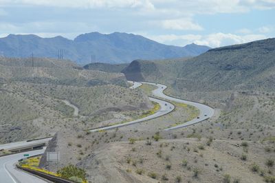 High angle view of road by mountains against sky