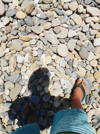 Low section of woman standing on cobblestone