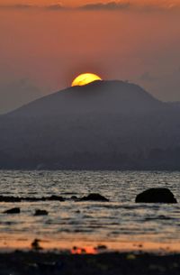 Scenic view of sea against orange sky
