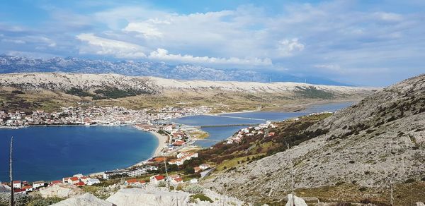 High angle view of sea and buildings against sky