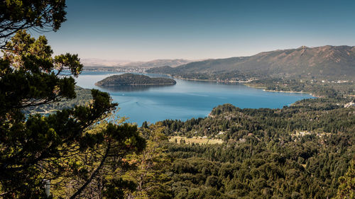 Scenic view of sea and mountains against clear sky