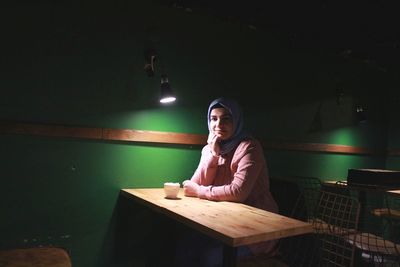 Portrait of smiling man sitting in restaurant