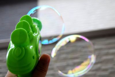 Close-up of person holding bubbles