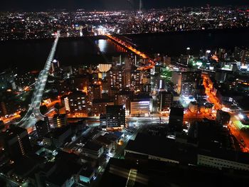 High angle view of illuminated city buildings at night