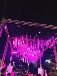 Low angle view of illuminated lanterns hanging at night