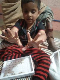 High angle view of girl playing with chocolate