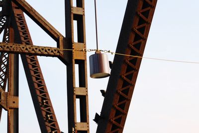 Low angle view of crane against sky