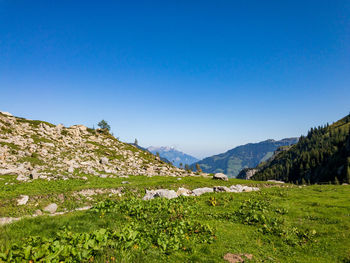 Scenic view of mountains against clear blue sky
