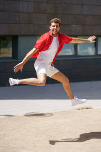Full length of young man jumping outdoors