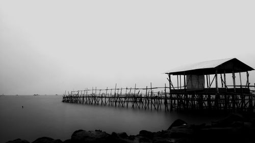 Pier over sea against clear sky