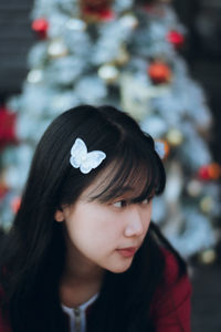 Close-up of young woman looking away at home