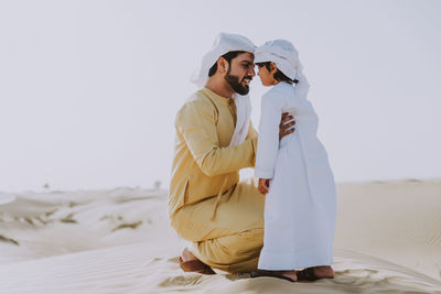 Rear view of couple standing outdoors