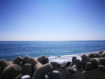 Scenic view of sea against clear blue sky